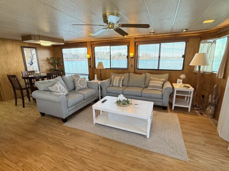 Living room with couches and lake windows