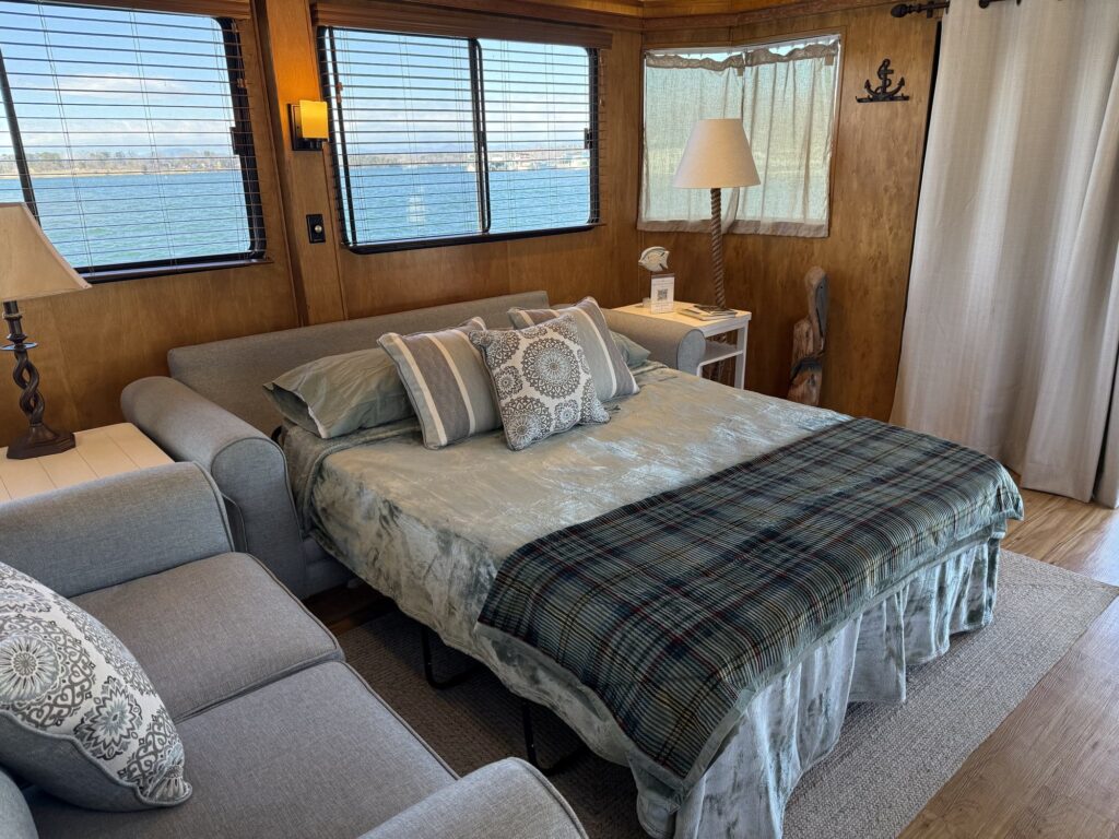 The living room sofa made up as a queen sleeper